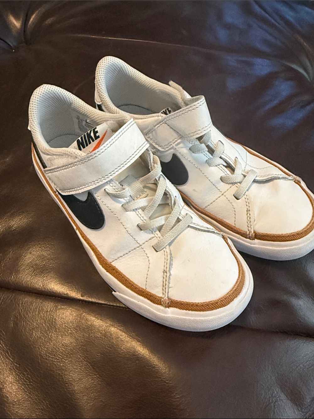 Nike Kids White Sneakers with Black Swoosh and Gold Trim